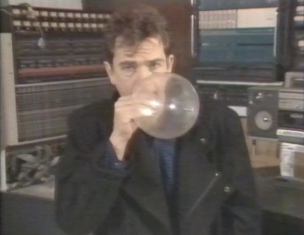 Peter Gabriel inflates a condom